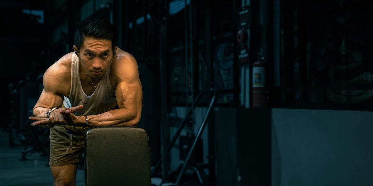 Muscular man rests at the gym.