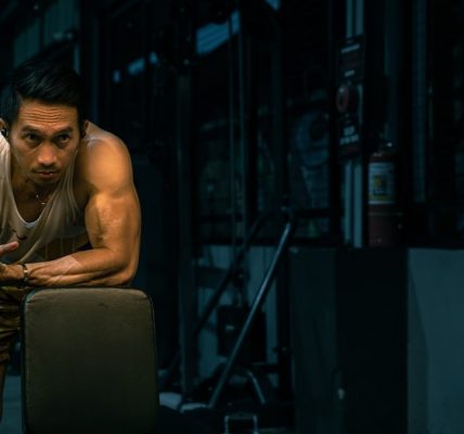 Muscular man rests at the gym.