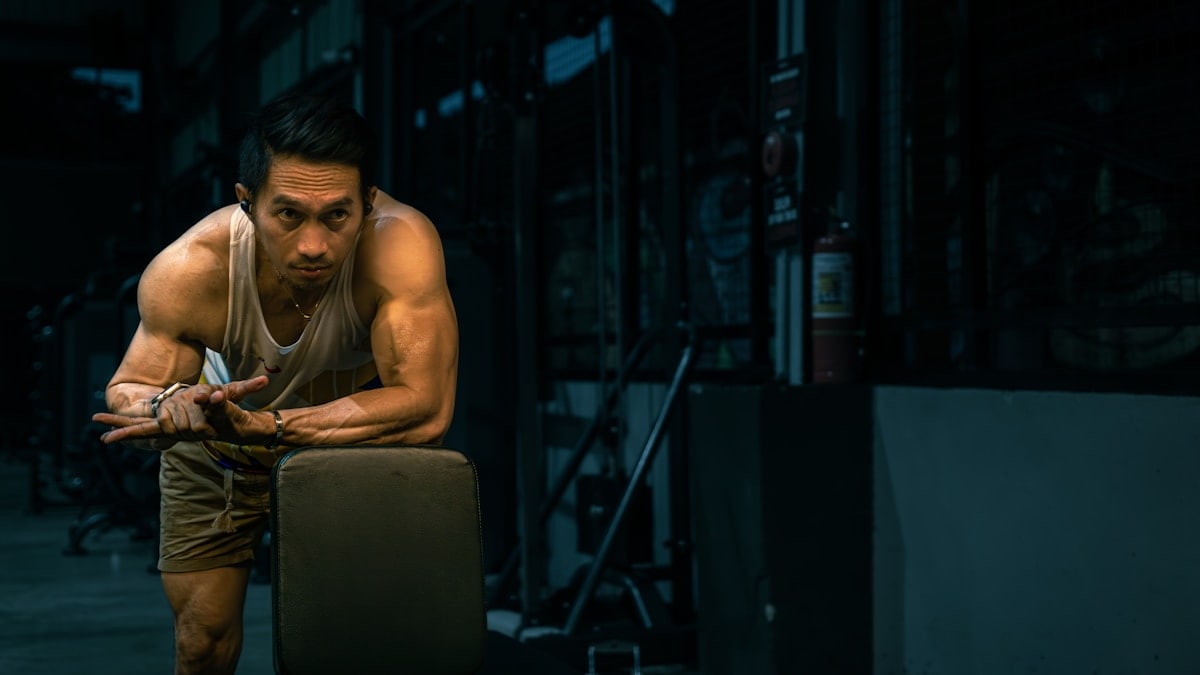 Muscular man rests at the gym.